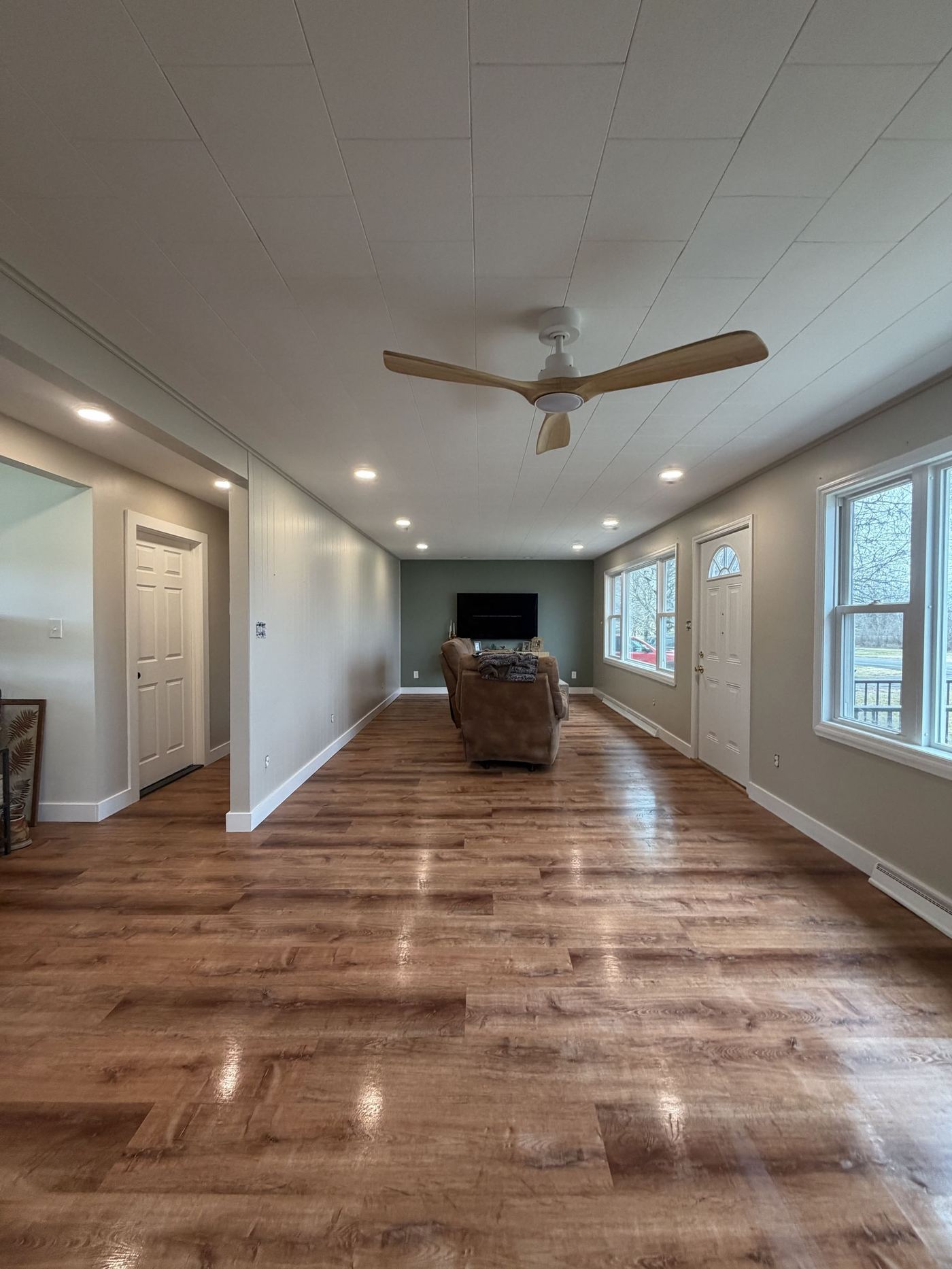 Interior painting — sage green living room with shiplap ceiling